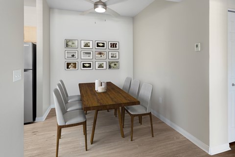 A dining room with a table and chairs.