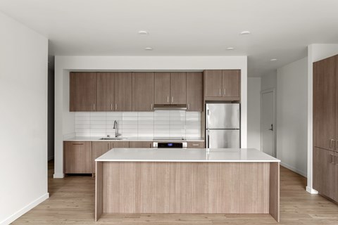 A modern kitchen with wooden cabinets and a white countertop.