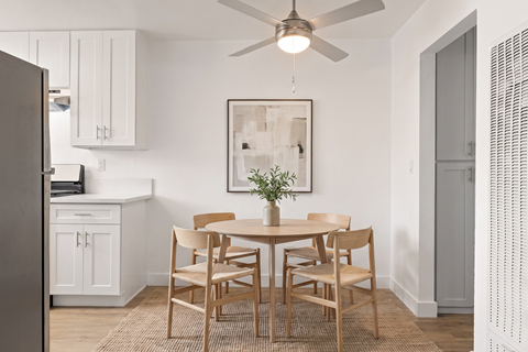 A dining room with a table set for six.