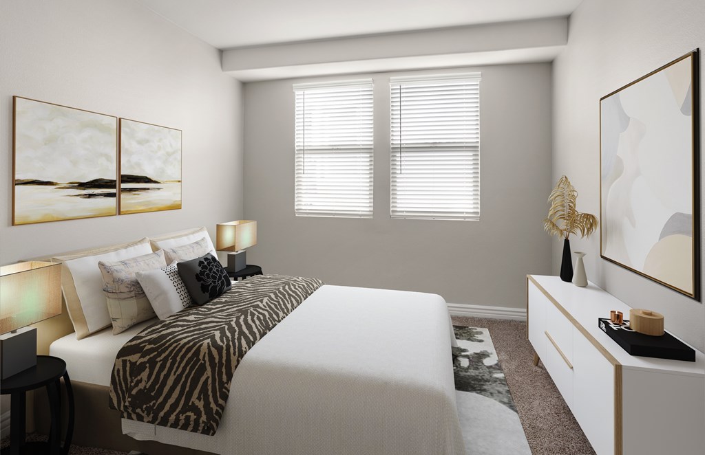 A bedroom with a zebra print bedspread and a white bed.