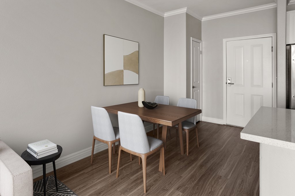 A dining room with a wooden table and chairs.