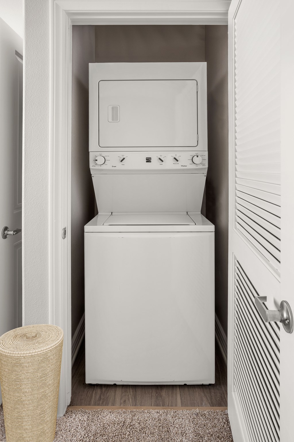 A white dryer and washing machine in a small laundry room.