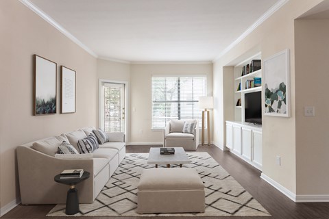 A living room with a white couch and a coffee table.
