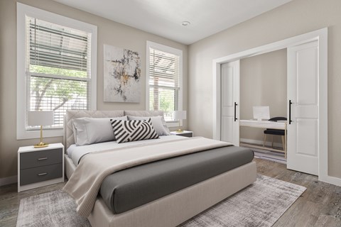 A bedroom with a large bed and a painting on the wall.
