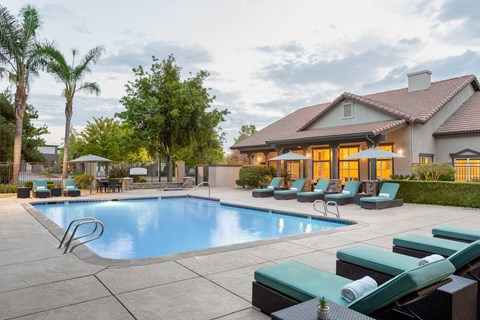 A large house with a pool in the backyard.