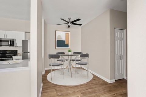 A dining area with a table and chairs is shown.
