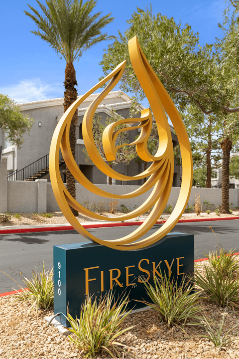 A large yellow sculpture sits in front of a sign that says "Fireskye".