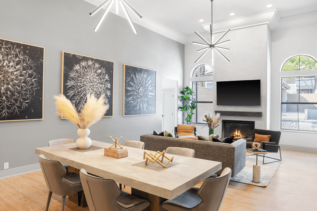 A modern dining room with a large table and chairs.