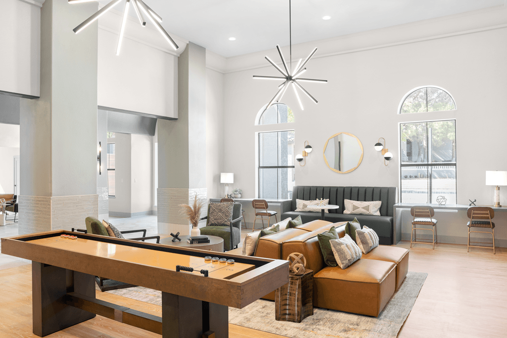 A modern living room with a pool table in the foreground.