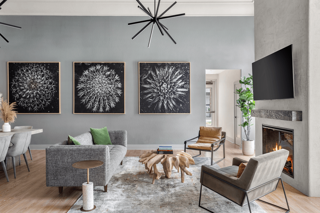A living room with grey walls and a fireplace.