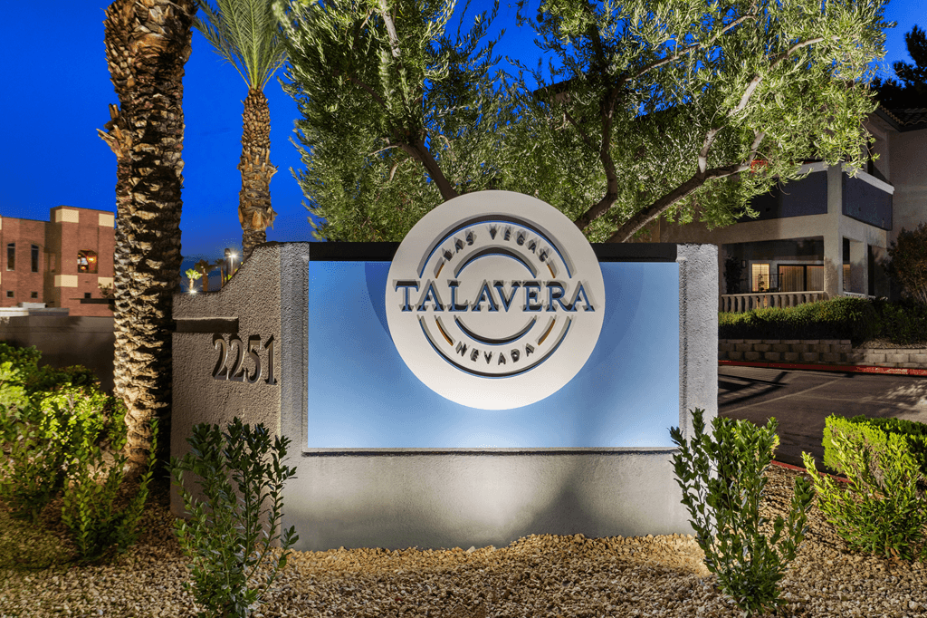 A sign for Talavera Village in Nevada is shown at dusk.