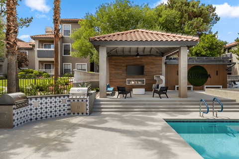 A pool area with a pavilion and a pool.