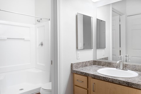 A bathroom with a white sink and a white toilet.