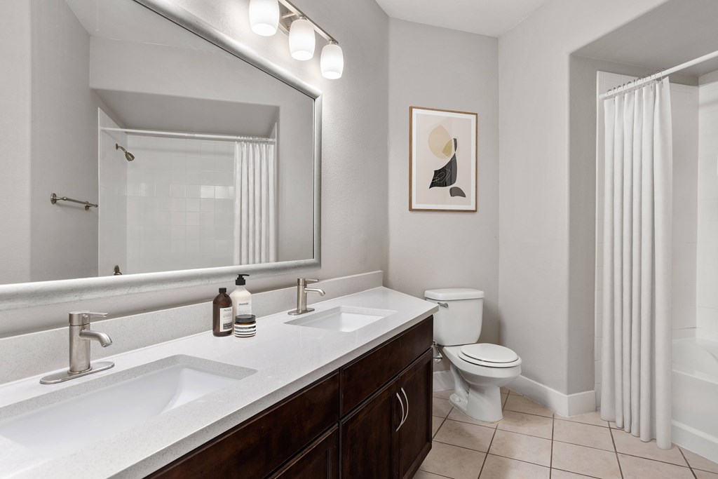 A bathroom with a white sink and a toilet.