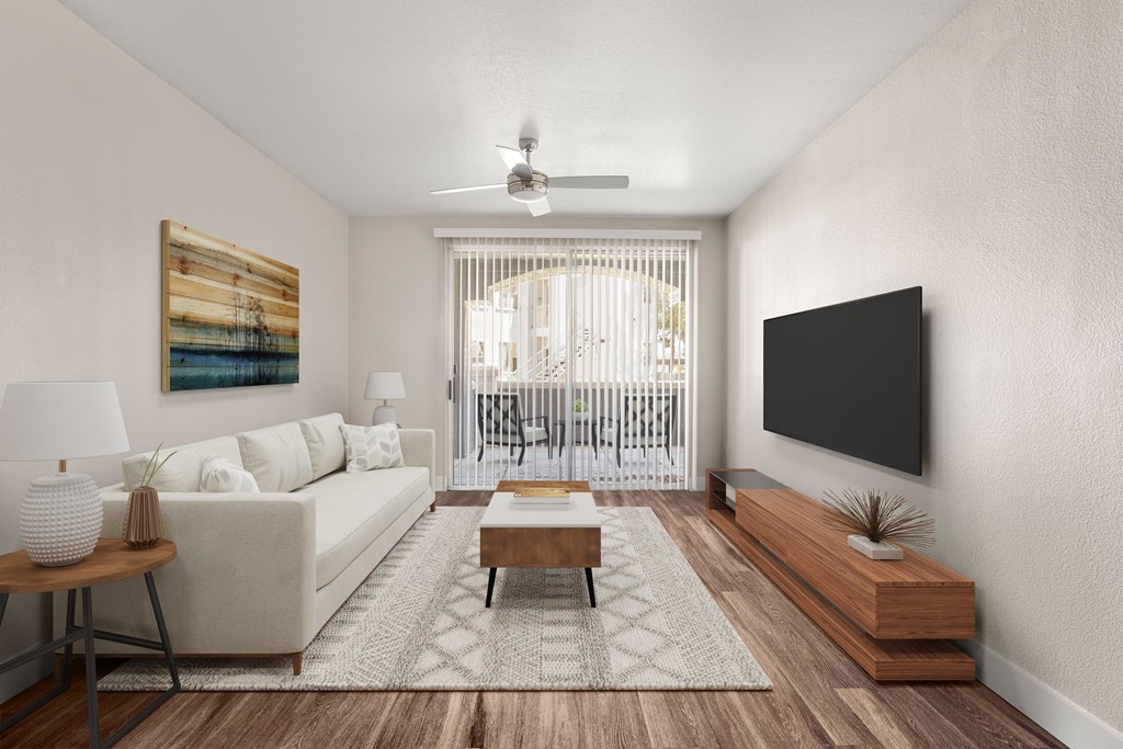 A living room with a white couch, a wooden coffee table, and a painting on the wall.