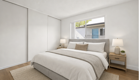 A bedroom with a large bed and a window.