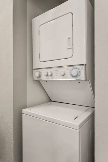 A white oven and dishwasher are installed in a wall.