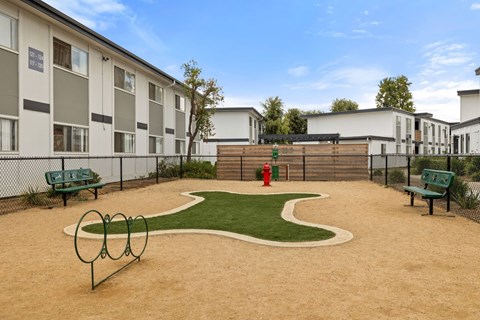 A playground area with a slide, swings, and a sandbox.