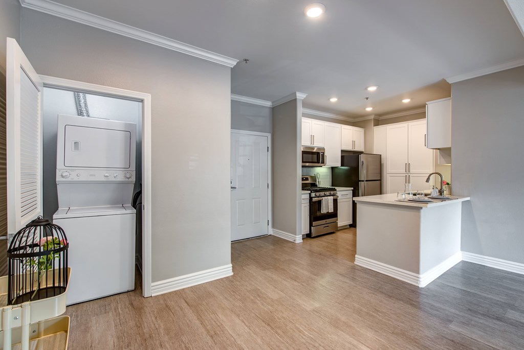 A kitchen with a white fridge and a white counter.