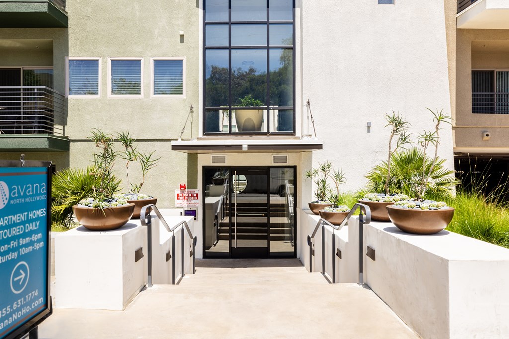 A white building with a sign in front of it that says