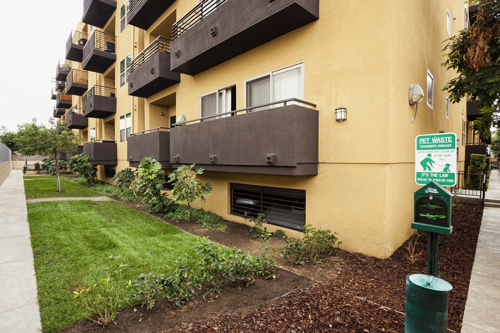 A sign on a pole in front of a building reads