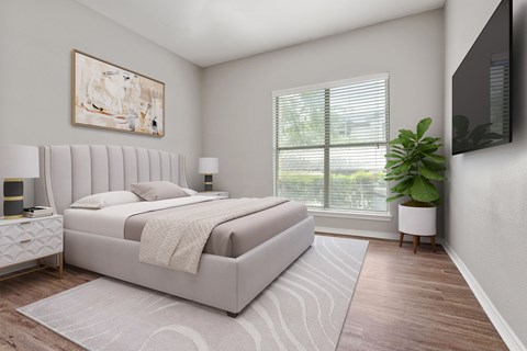 A bedroom with a large bed and a painting on the wall.