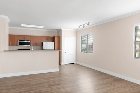 A kitchen area with a microwave and refrigerator.