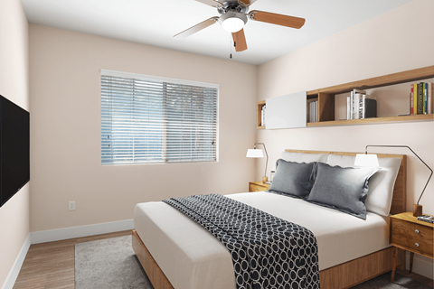 A bedroom with a bed, a ceiling fan, and a window with blinds.