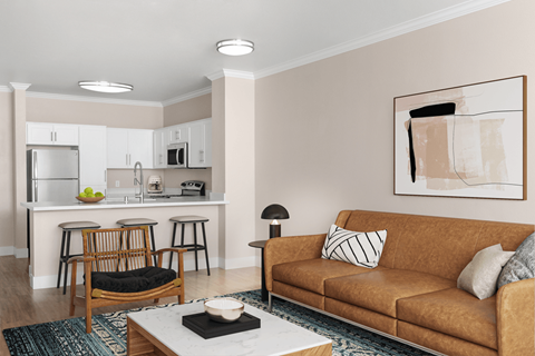 A living room with a brown couch and a wooden chair.