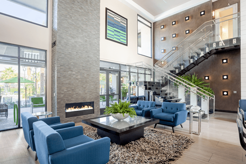 A modern living room with a fireplace and a staircase.