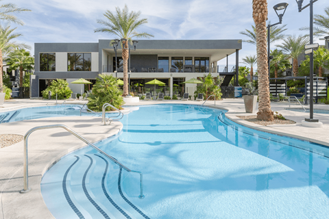 A swimming pool in front of a modern building.