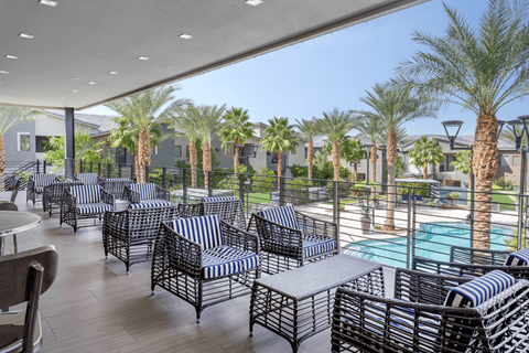 A patio with black and white striped chairs and tables.