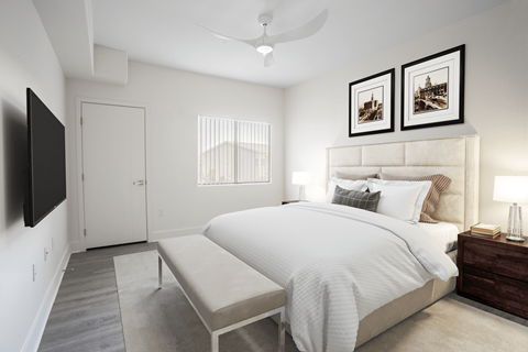 A bedroom with a large bed and a flat screen TV mounted on the wall.