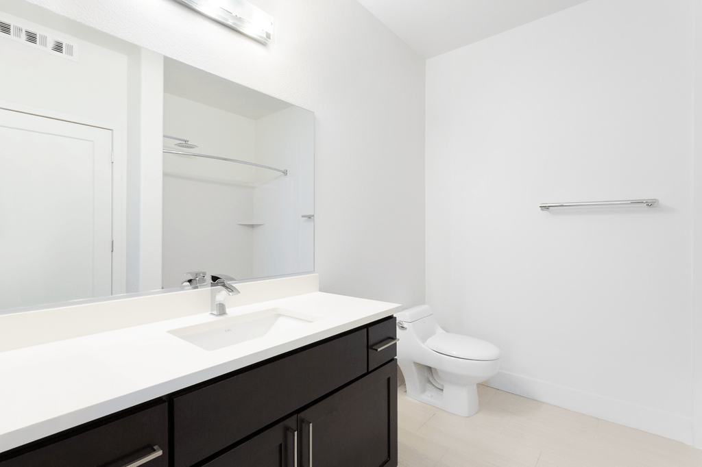 A white bathroom with a toilet and sink.