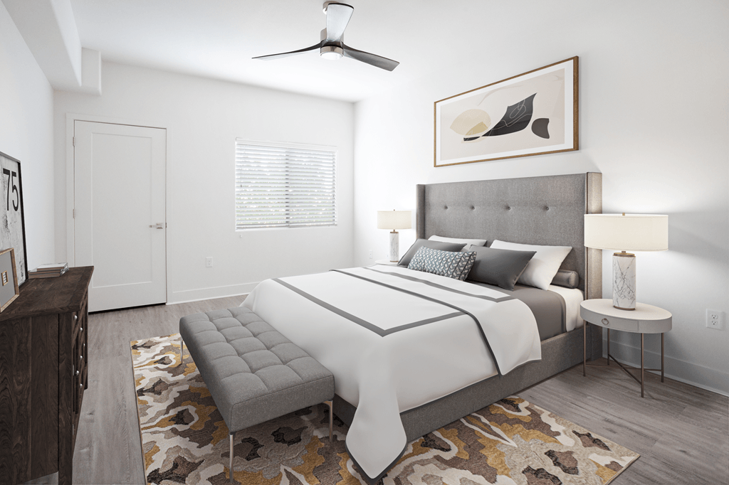 A bedroom with a large bed and a bench in front of it.