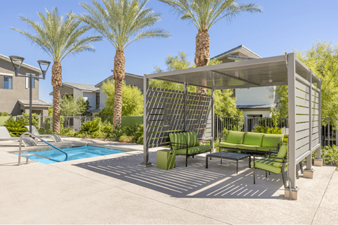 A patio with a table and chairs under a canopy.