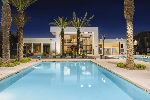 A modern house with a pool in the front yard.