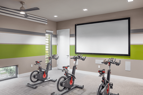 A room with a green wall and a white screen on the wall.