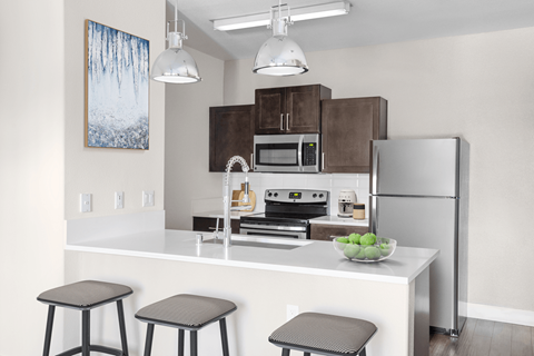 A kitchen with a white countertop and a refrigerator.