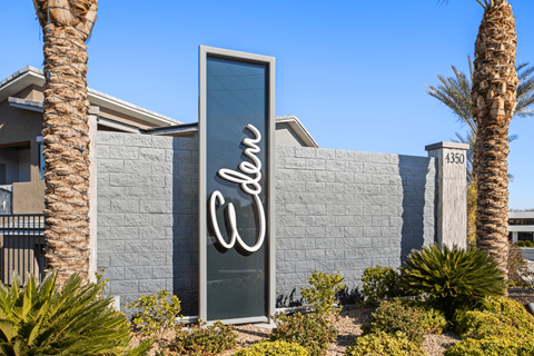 A tall, narrow sign with the word "Eldorado" written in cursive on it is displayed in front of a building.