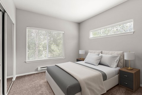 A bedroom with a large bed, a nightstand with a lamp, and a window with blinds.
