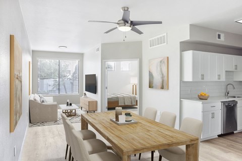 A modern dining room with a wooden table and chairs.