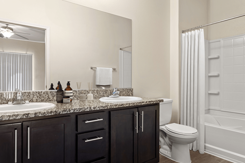 A bathroom with a white toilet, sink, and bathtub.