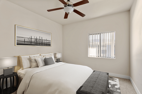 A bedroom with a large bed and a ceiling fan.