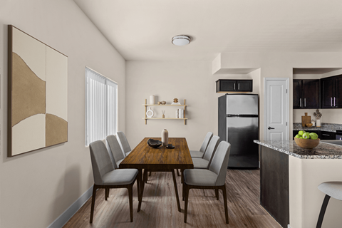 A modern kitchen with a dining table and chairs.