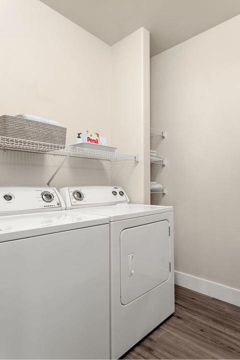 A white washing machine and dryer in a laundry room.