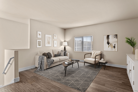 A living room with a couch, chair, and a coffee table.