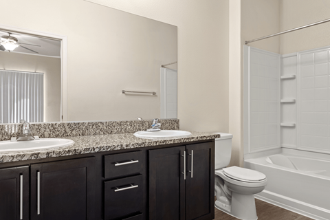 A bathroom with a sink, toilet, and bathtub.