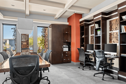 A conference room with a long table and chairs.
