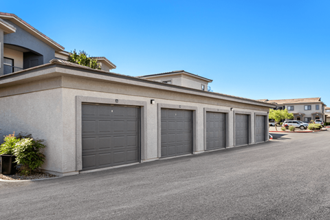 A row of garage doors in front of a building.